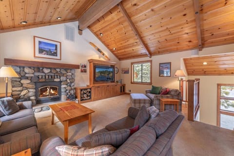 Lovely great room on main / upper floor with vaulted ceilings, fireplace and large flat screen TV.