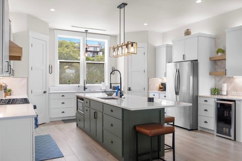 Full size fridge with dual ice makers and a second sink with a view.