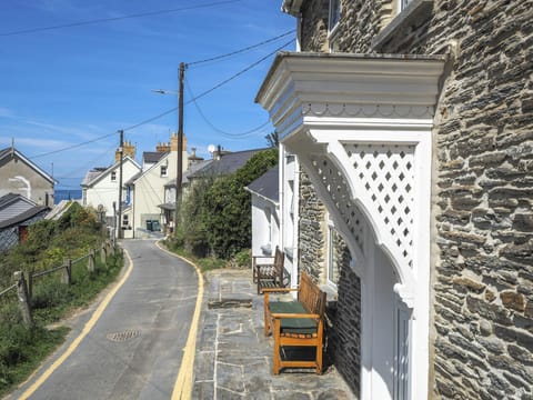 View across front of Bywell showing the road leading to the beach and a distant sea view