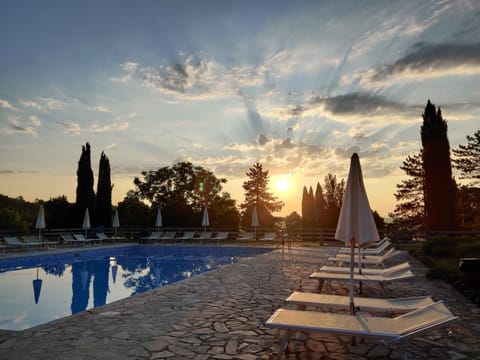 Seasonal outdoor pool, open 9:00 AM to 8:00 PM, pool umbrellas