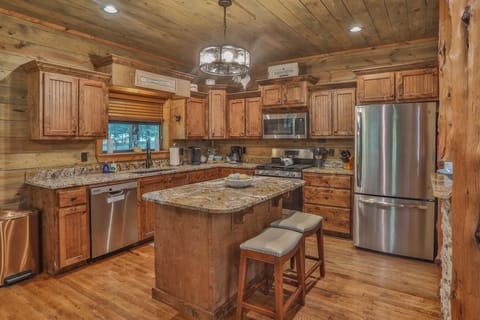 Fully equipped and brimming with rustic charm, this kitchen features granite countertops and stainless steel appliance