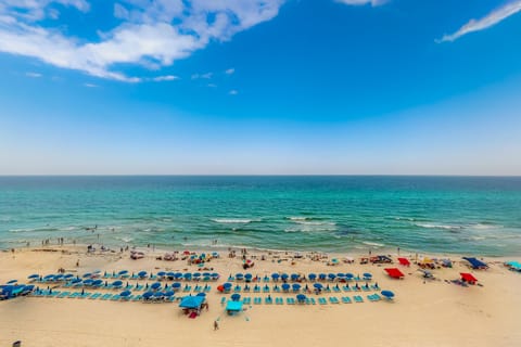 On the beach, white sand, sun loungers, beach umbrellas