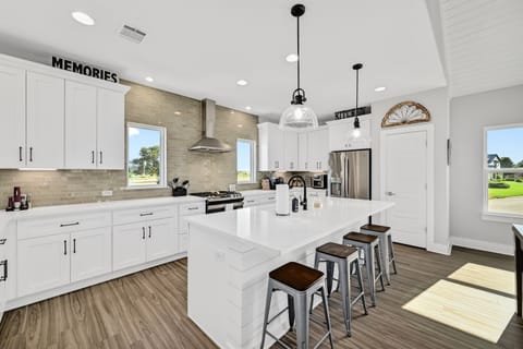 Kitchen with large counter and stools