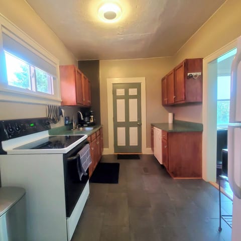 Full Kitchen with Exit to Backyard
Stove, Oven, Microwave & Refrigerator Freezer