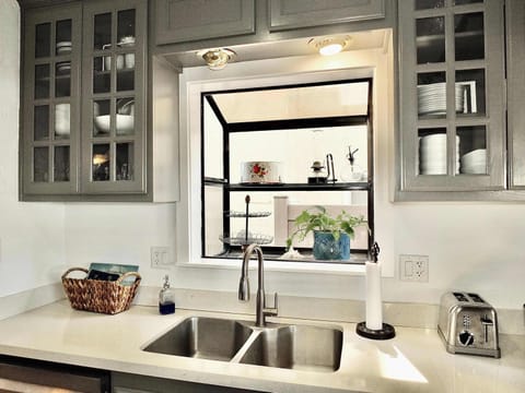 The airy kitchen offers ample space & all the comforts of home