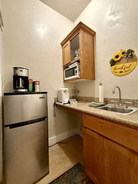 Kitchenette with the essentials:  refrigerator, microwave, sink, and drip coffee maker