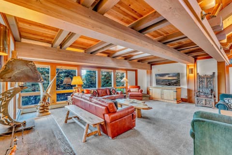 Living Room 5 couches, 55” Smart TV, 4-person dining table, decorative fireplace, access to 2 decks
