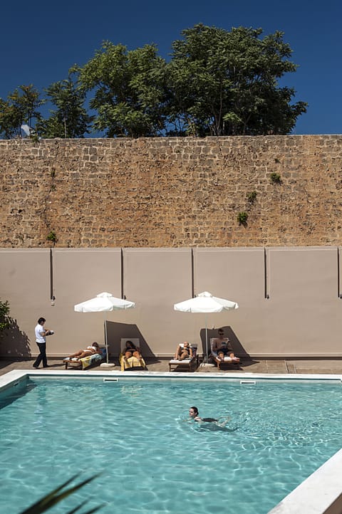 Seasonal outdoor pool, open 8:00 AM to 8:00 PM, pool umbrellas