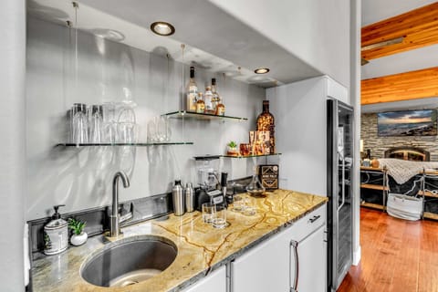 Dining Room: 6-person dining table, bar area, large wine fridge, adjacent to kitchen and living room