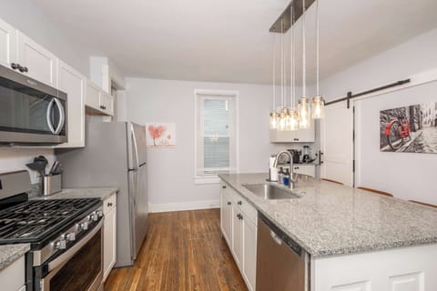 The chic, breezy kitchen offers ample space & every home comfort