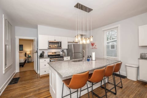 The chic, breezy kitchen offers ample space & every home comfort