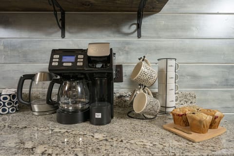 Cozy coffee station with fresh muffins and charming mugs—perfect morning start!