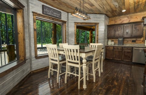 Rustic dining room with cozy wooden charm and beautiful forest views.