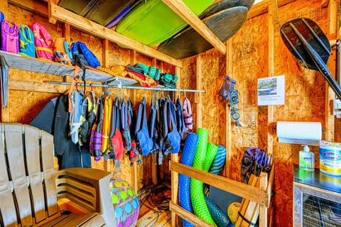 Gear up for adventure in this well-stocked shed featuring life jackets, paddleboards, and water toys, ensuring fun-filled days on the lake.