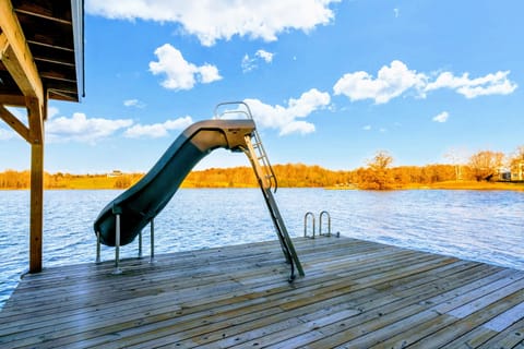 Fun lakeside dock with a water slide and ladder, perfect for swimming and water activities