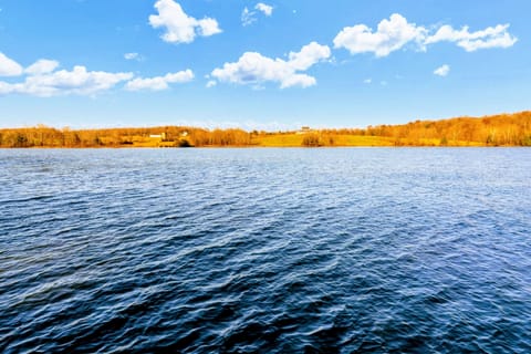 Serene lake view with clear blue water and scenic natural surroundings, perfect for a peaceful getaway