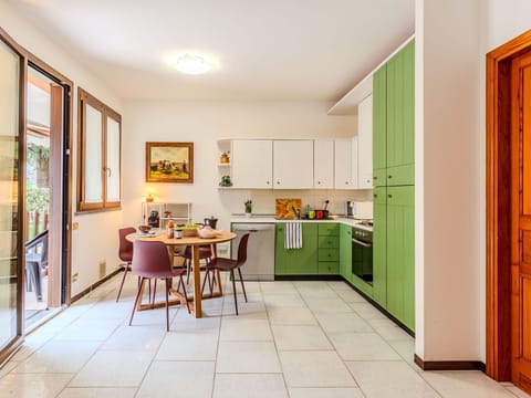 Furniture, Table, Cabinetry, Countertop, Building, Houseplant, Picture Frame, Wood, Flooring, Door