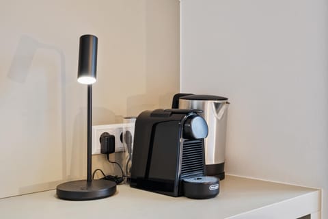  Desk space with a coffee maker and kettle for added convenience.