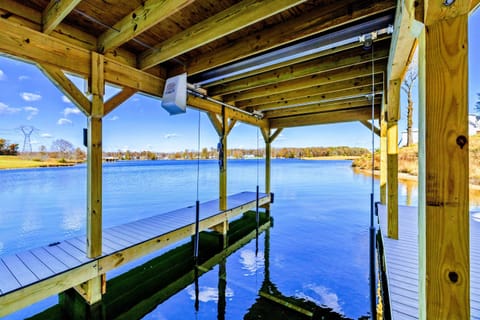 Covered dock with cozy seating and boat slips, providing a perfect mix of relaxation and water access on a peaceful lake.