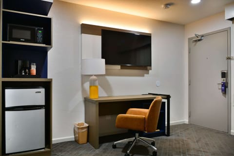 Suite, 1 King Bed, Non Smoking | Desk, laptop workspace, blackout drapes, iron/ironing board