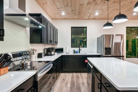 Culinary adventures await in this sleek, modern kitchen with stylish accents and ample space!