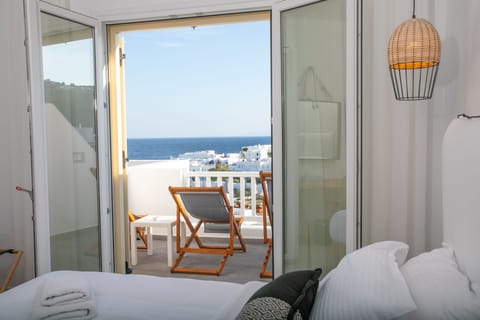 Deluxe Quadruple Room, 1 Bedroom, Sea View | In-room safe, desk, laptop workspace, blackout drapes