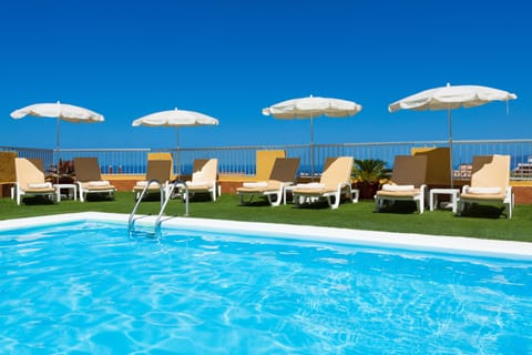 Outdoor pool, open 10:00 AM to 6:00 PM, pool umbrellas, sun loungers