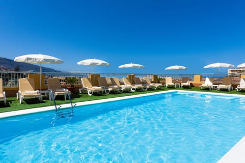 Outdoor pool, open 10:00 AM to 6:00 PM, pool umbrellas, sun loungers