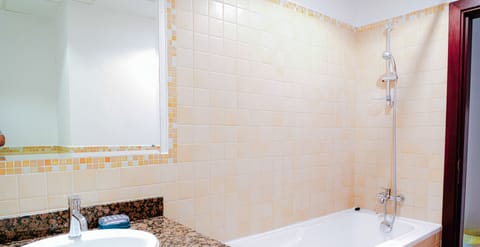 Separate tub and shower, hair dryer, towels, toilet paper