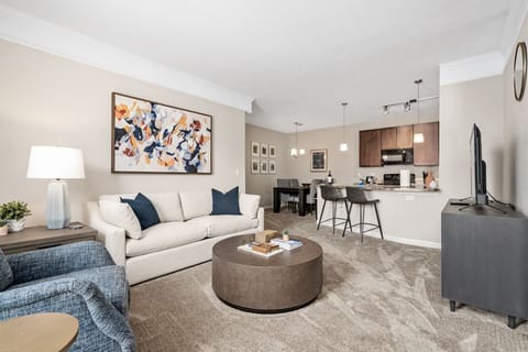 Open concept living area showing living room, dining area, and kitchen 