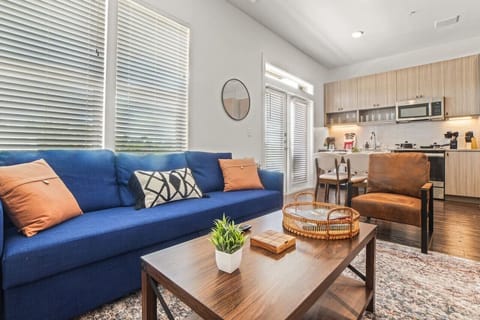 Bright and airy living room with plush seating, a large TV, and tasteful decor, creating the perfect space for relaxation and entertainment.