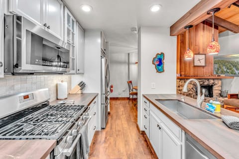 Kitchen: Well-equipped kitchen, Keurig, Crockpot, waffle maker, open layout to living room