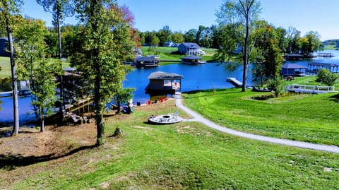 Unwind by the lakeside fire pit, surrounded by stunning water views and outdoor amenities for a perfect retreat.
