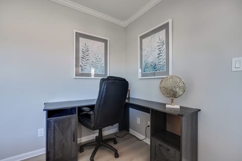 A dedicated work space with a comfortable setup, perfect for remote work or studying.