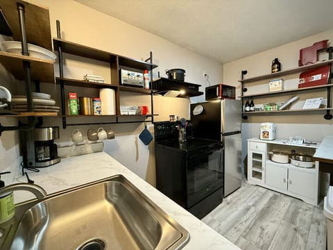 This small kitchen has everything you need to cook-in during your stay.