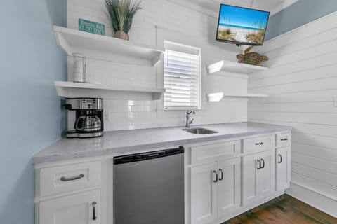 Coffee maker, mini-fridge, sink, and TV