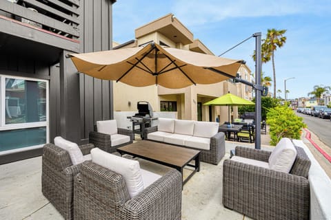 Shaded outdoor lounge with plenty of seating, perfect for morning coffee, casual meals, or unwinding after a beach day.