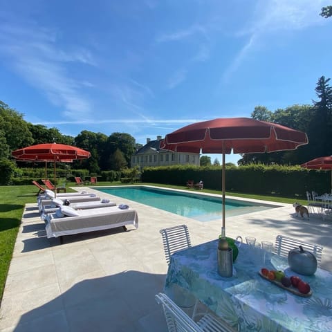 Seasonal outdoor pool, open 2:00 PM to 7:00 PM, pool umbrellas