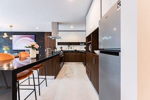 Spacious kitchen with sleek countertops and top-of-the-line appliances.