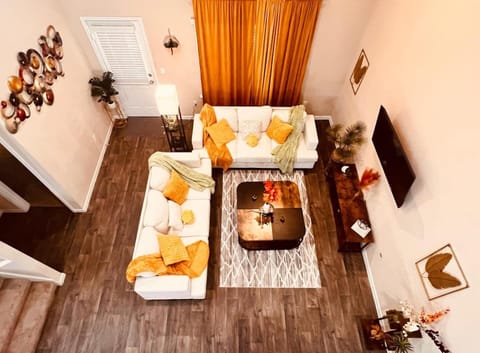 Bright and stylish living room with cozy seating, vibrant decor, and plenty of natural light. Relax after a day exploring nearby attractions like EVO Entertainment or Historic Downtown Kyle.