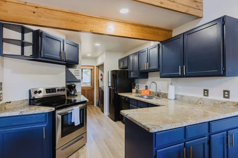 Kitchen - Our fully equipped kitchen offers plenty of space to prepare meals while being open to the living and dinning area.