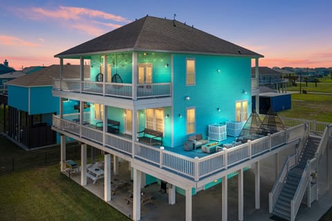 Experience ultimate coastal living featuring expansive wraparound decks and cozy outdoor seating.