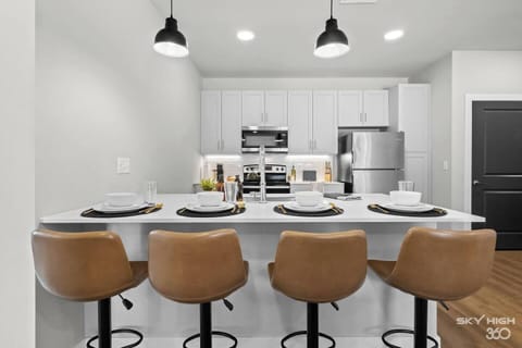 Dine-in with a fully equipped kitchen, complete with sleek appliances and plenty of counter space.