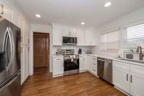 The sophisticated kitchen offers ample space & every home comfort