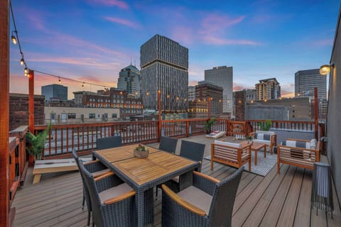 Find yourself captivated by the beauty of the skyline, where cityscape bliss meets a charming rooftop deck..
