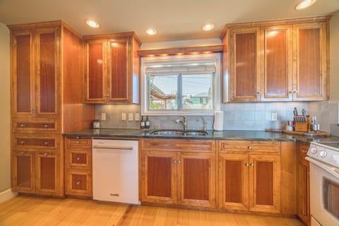 Kitchen complete with appliances, oil, vinegar, and cooking utensils.