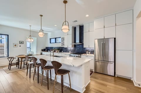 Sleek and modern design meets functionality in this fully stocked kitchen.