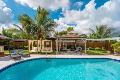 This lovely backyard space is the epitome of luxury! Live like a rockstar and dive into the swimming pool, hang out comfortably under the cabanas, play some minigolf or suntan in the lounge chair.