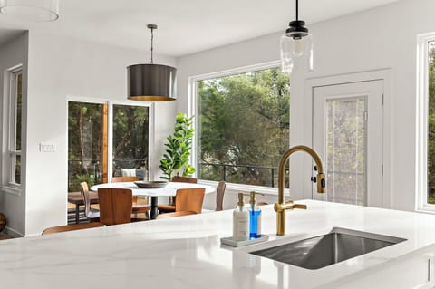 Sleek kitchen design with a bright and airy dining space.