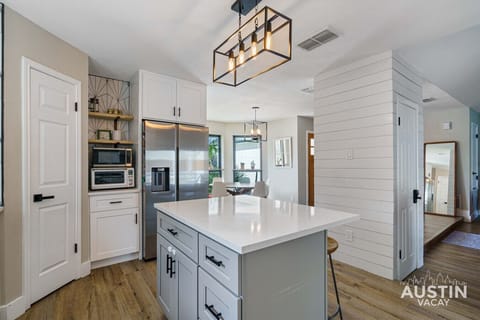 From the sleek countertops to the modern lighting, this kitchen is both beautiful and functional. The large island provides ample space for cooking and entertaining, making it the perfect hub for your stay